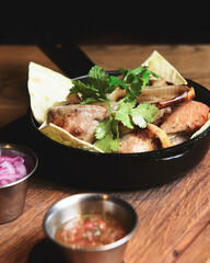 Grilled shashlik served on lavash bread in a frying pan. Shashlik or Shish kebab.