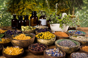 Natural medicine and mortar, healing herbs background