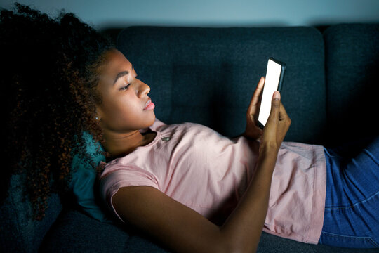 Alone Young Black Woman Using Smartphone At Night