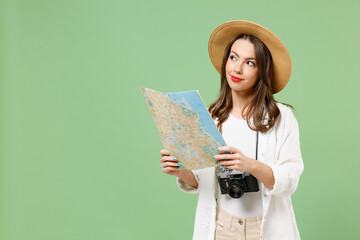 Traveler exploring dreamful tourist woman in casual clothes hat camera hold paper map during...