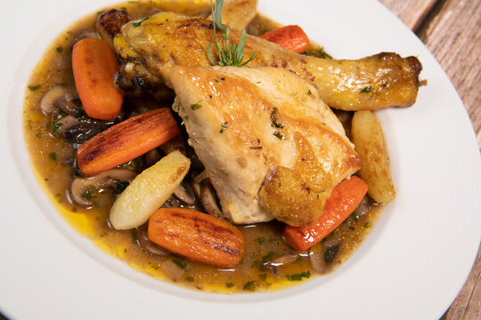 Chicken Hunter recipe with glazed root vegetables, carrot, turnip with its mushroom sauce deglazed in white wine and wet with the chicken stock