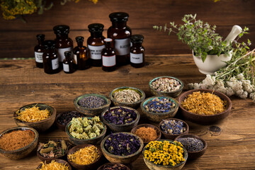 Homeopathy, herbal medicine on wooden table