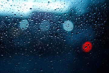 Rain drops on the car windshield.