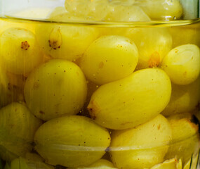 Preserved white grapes. Grape compote in glass jar.
