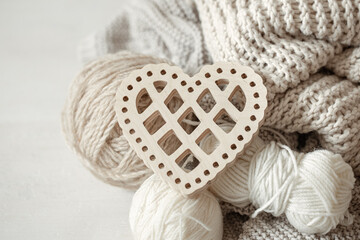 Close-up of yarn in pastel colors and decorative heart.