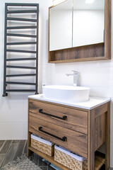 Modern bathroom interior with wooden furniture close up.