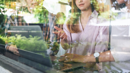 A group of business people using laptop computer while working together indoors
