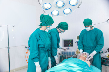 practitioner performing surgical operation in hospital operating room. Surgeon is operating a...