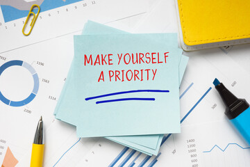 Business concept meaning MAKE YOURSELF A PRIORITY with sign on the page.