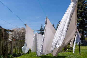 fresh clean sheet and lnaundry drying on washing line in outdoor