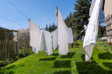 fresh clean sheet and lnaundry drying on washing line in outdoor
