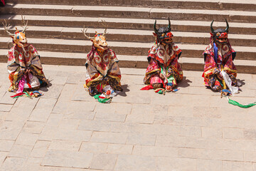 Dancers with traditional costumes and masks during a religious performance in the ancient Kumbum monastery in the vicinity of Xining, Qinghai, China 