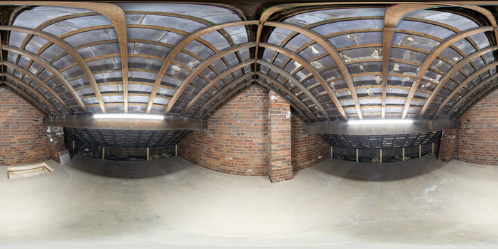 360 Degree Full Sphere Panoramic photo of a typical British loft in a terrace house showing the bare bricks and wooden beams with the roof tiles on the outside and a loft hatch in the corner