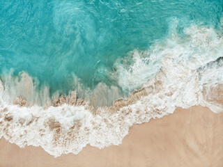 Bird's-eye view on a breaking wave at Kelingking Beach, Nusa Penida (Indonesia)