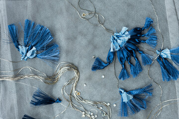 Blue flowers with silver chain on silver textile