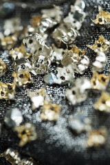 Metal silver and golden objects on textile