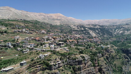 Lebanese village near the valley. Aerial 4k footage of the city and valley. Best hiking trails. Middle East country. Summer vacation in Lebanon. Village from bird's eye view. City landscape view