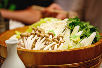 Shabu-shabu is a Japanese nabemono hotpot dish of thinly sliced meat and vegetables boiled in water and served with dipping sauces. Preparation of shabu shabu