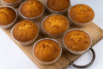 Biscuit muffins close-up. Sweet pastries. Party treat. Dessert on white table - homemade muffins. Portioned cupcakes. Simple muffin