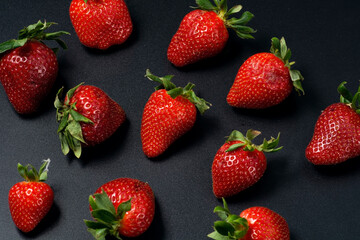 Juicy strawberries on a black background.
