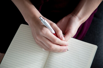 lady holding a pen to take notes