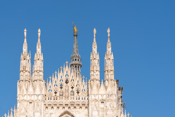 Fototapeta na wymiar Details of Duomo with the golden statue name 
