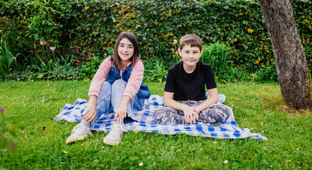 Friends sitting on a blanket in garden