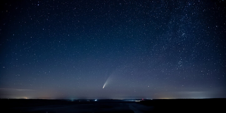 Wonderful view of starry sky and C/2020 F3 (NEOWISE) comet with light tail.