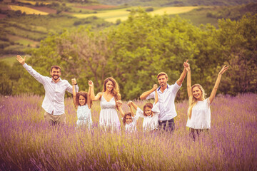 Naklejka na ściany i meble Large group of people standing in lavender filed.