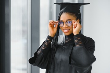 Closeup portrait of happy female student with certificate in college campus