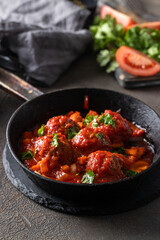 Frying pan with homemade Meatballs in tomato sauce with parsley .