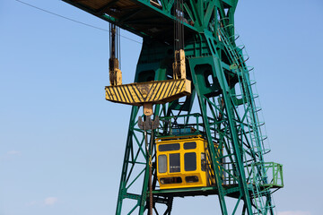 close-up of a gantry crane cabin and a hook with slings.