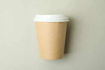 Blank paper cup on light gray background, space for text