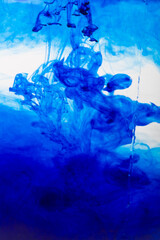A blue cloud of ink in water isolated on a white background.
