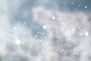Fototapeta na wymiar blue snowfall bokeh background, abstract snowflake background on blurred abstract blue