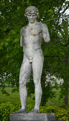 Fototapeta na wymiar Statue of a young Greek or Roman man, naked, with broken arms