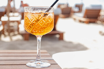 Close-up of crystal glass with orange drink.