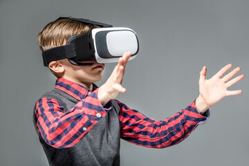 Boy in virtual reality glasses playing the game