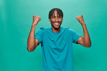 Young Black Wearing a blue t-shirt Over A Turquoise Background