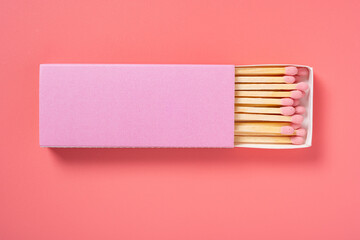 pink color matchbox and pink match sticks on a pink background