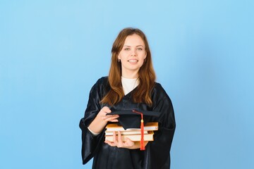 Obraz premium Beautiful woman wearing graduation cap and ceremony robe holding degree looking positive and happy standing and smiling with a confident smile.