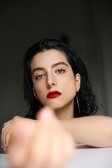 Vertical headshot of young caucasian woman with natural beauty studio portrait.