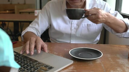 Worker using laptop in coworking space or café and drinking tea. Study, working, remote work, freelance concept. 