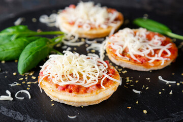Mini pizzas with sausages and cheese