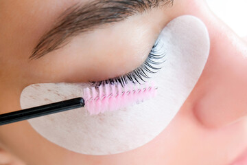 Young woman receiving eyelash lamination procedure
