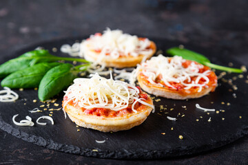 Mini pizzas with sausages and cheese