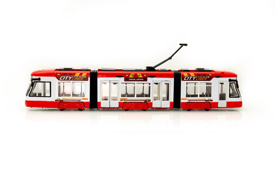 Red tram on a white background. Children's toy. Urban transport concept.