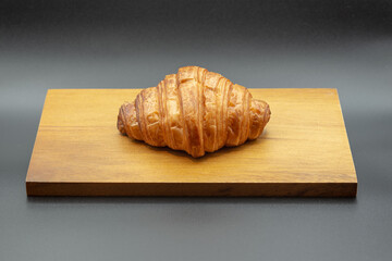 croissant on wooden cutting board