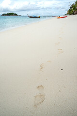 footprints on the beach that tracking someone walking from kayak
