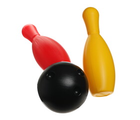Black bowling ball striking pins, skittles in air isolated on white background, clipping path